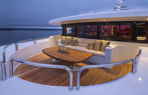 A table and sofa positioned outside the bridge of a superyacht