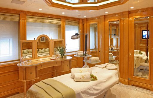Treatment room with central massage table onboard private yacht charter ST DAVID