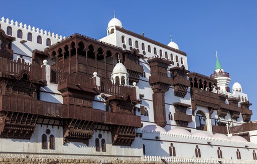 Old town in Jeddah, Saudi Arabia. Overlooking white structure adorned with dark wood.