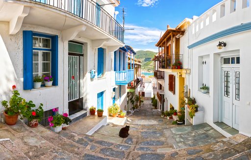 A village street leading to a quaint harbour on Skopelos island in the Sporades, Greece