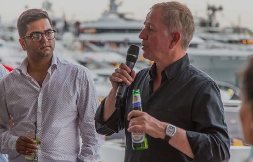 A speaker at a corporate event on board a superyacht at the Monaco Grand Prix