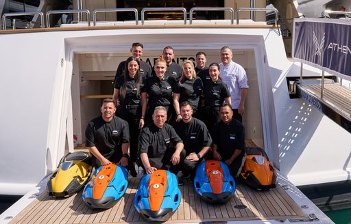 Superyacht charter crew posing in an open transom