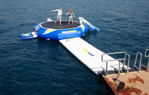 charter guests enjoying aquaglide trampoline on board luxury yacht Panthalassa