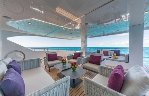 Alfresco lounge area onboard charter yacht BIG SKY, with surrounding views of the sea