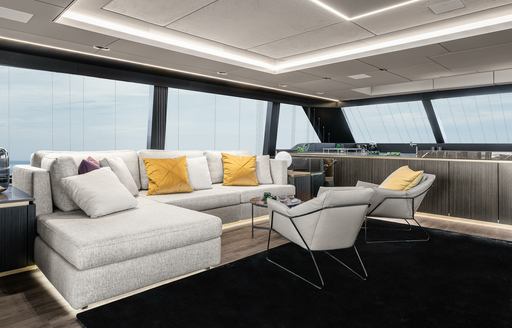 the stylish and chic upper loung of superyacht The main salon of charter yacht OTOCTONE 80 