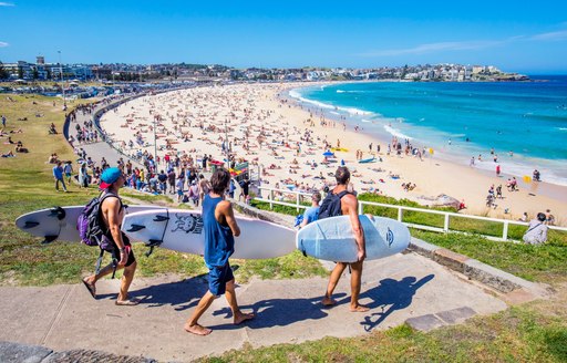 surfers head down to Bondi Beach in Australia