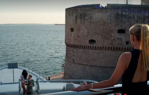 woman overlooking the Mediterranean sea on board superyacht kismet while filming the netflix block buster 6 underground