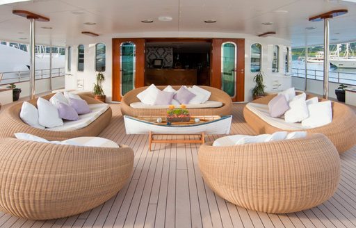 Wicker sofas on the deck of superyacht Sherakhan