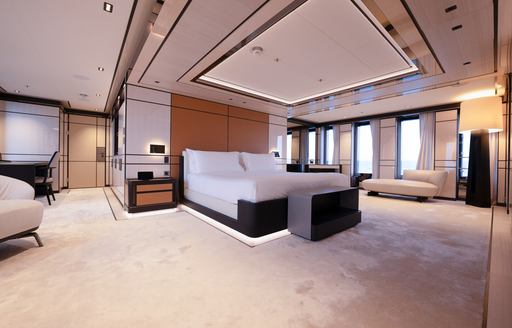 Overview of the master cabin onboard charter yacht RELIANCE, central berth with multiple windows in background