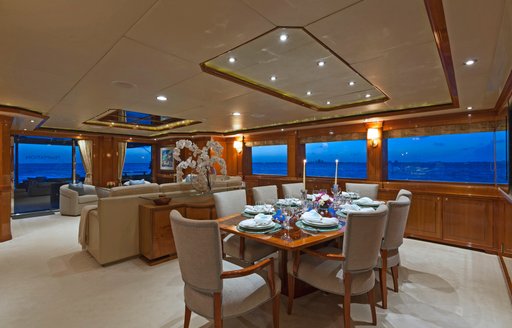 sophisticated dining area in main salon aboard charter yacht TEMPTATION