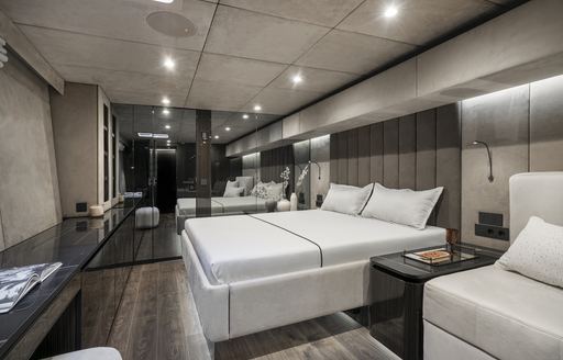 Master cabin onboard S/Y GREY B, central berth facing port with large mirrors in background