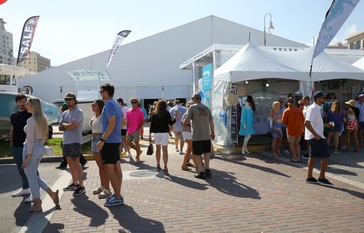 Exhibitor tents at the Palm Beach International Boat Show, with many visitors walking around