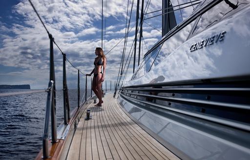 charter guests takes in beautiful views from side deck of charter yacht GENEVIEVE