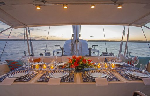 aft cockpit dining table set for dinner as the sun goes down aboard luxury yacht JUPITER 