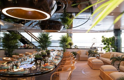 Lots of potted plants surround dining area onboard