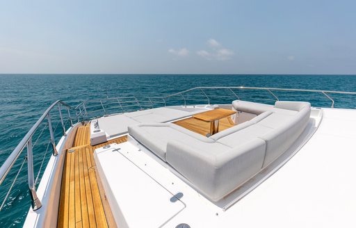 Overview of the bow onboard charter yacht VESTA, with a sun pad and seating area center