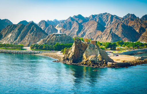 mountains by the water in oman, with rugged landscape