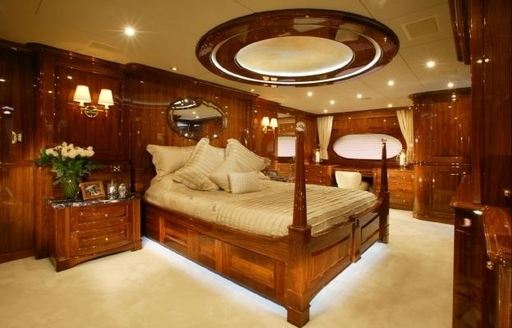 rich lacquered timbers and neutral decor in master suite on board luxury yacht ‘Top Five’ 