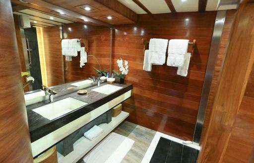 en-suite bathroom on board superyacht LAMIMA with wooden wall panels