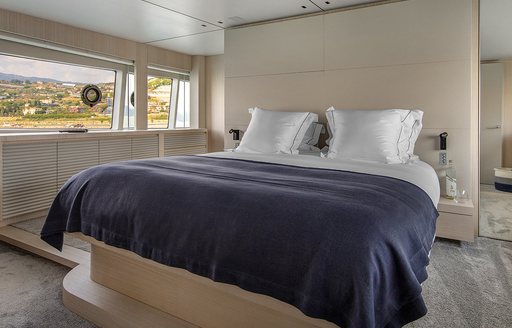 Cabin and double bed on luxury yacht ARSANA with light furnishing and long window