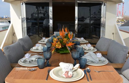 Alfresco dining setup on the exterior decks of charter yacht XIPHIAS