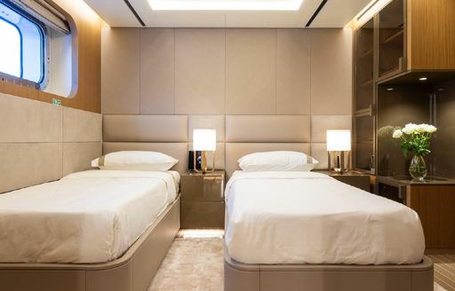 Overview of a twin cabin onboard charter yacht ALFA, twin beds with a window port side 