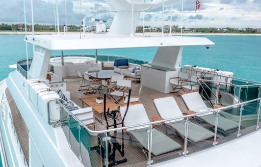 Overview of the sun deck onboard charter yacht Far Niente, with sun loungers in the foreground