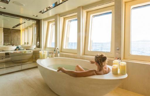 woman enjoying a relaxing bath on board her charter yacht 