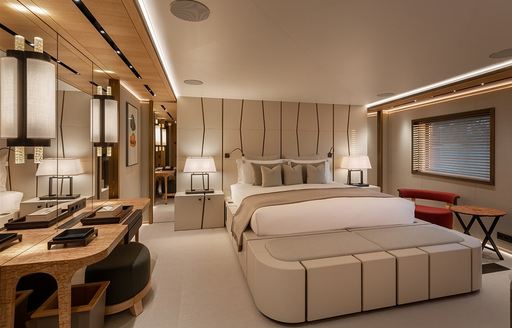 Guest cabin onboard charter yacht LA DATCHA, central berth facing forward with bureau in the foreground