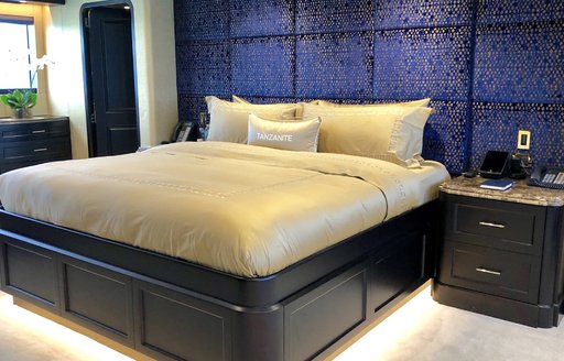 large bed in the centre of the master suite aboard motor yacht TANZANITE 