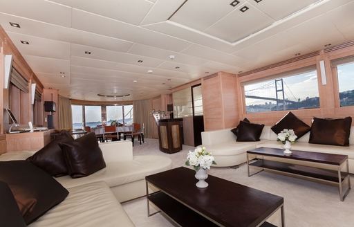 lounge with two L-shaped sofas in main salon of motor yacht CANPARK 