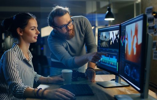 Man and woman use video editing suite