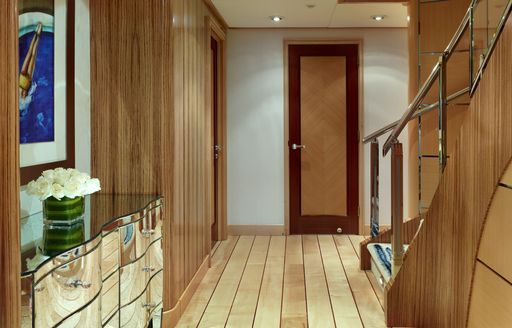 Wooden panelled corridor on Victoria Del Mar with staircase visible