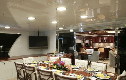 alfresco dining setup on the upper deck aft of charter yacht CLAIRE