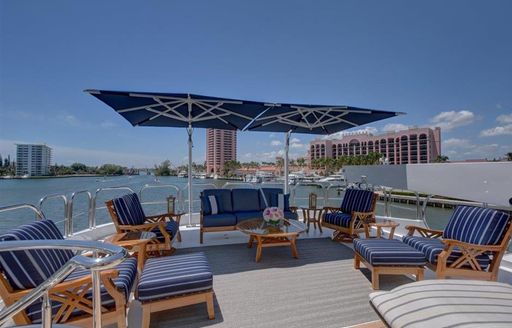 Sun deck with sun loungers aboard luxury yacht AQUASITION with Floridian skyline