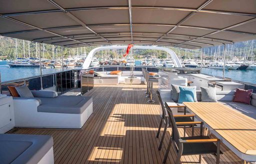 Exterior deck onboard sailing yacht charter NORTH WIND with dining area starboard and seating to port