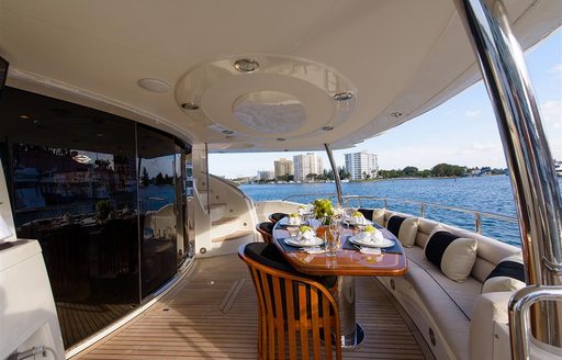 Exterior dining area onboard charter yacht CATALANA