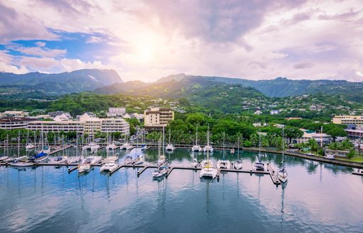 superyachts docked in a port in Tahiti