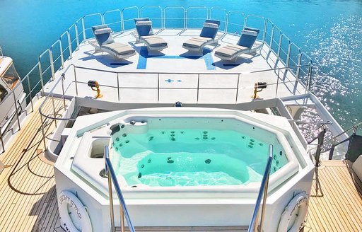 The deck aboard superyacht rental leight star, beautiful jacuzzi and hot tub area for guests to enjoy