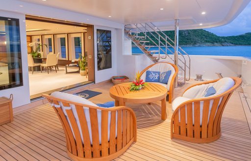 chairs and coffee table on the main deck aft of superyacht GLADIATOR 
