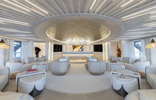 Interior seating area onboard superyacht charter KISMET with cream sofas and armchairs