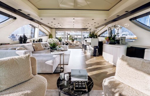 Main salon onboard boat charter MRS GREY, extensive lounge area with cream seating in the foreground