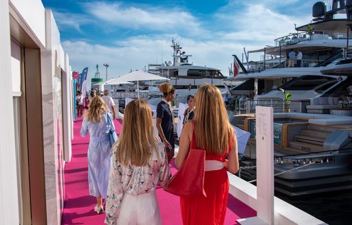 Ladies walking on a red carpet at the Cannes Yachting Festival