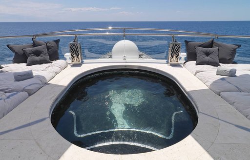 Swimming pool onboard charter yacht SILVER ANGEL, with surrounding views of the sea and spacious sun pads.