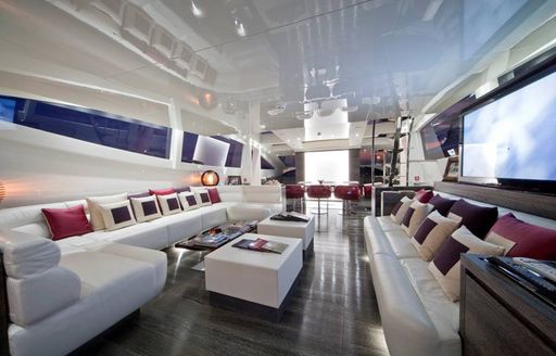 Main salon of superyacht TOBY, with TV screen and sofa seating 