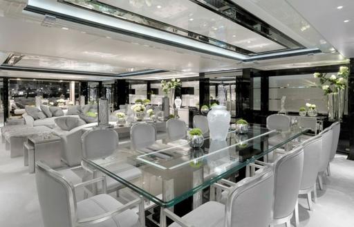 Formal dining area onboard charter yacht SILVER ANGEL, elaborate dining table with grey dining chairs