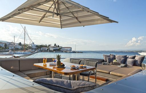 shaded foredeck of luxury yacht 'My Toy' with alfresco dining and sunning options