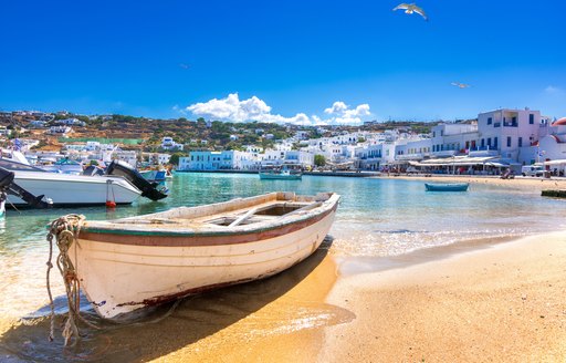 Small boats on a beach in Mykonos harbor in Greece