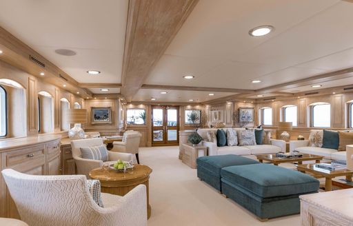 Overview of the main salon onboard charter yacht NERO with a spacious lounge area and many windows