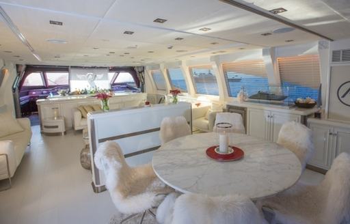 Cocktail area on superyacht ASCARI I with seating areas with fluffy chairs and marble accents